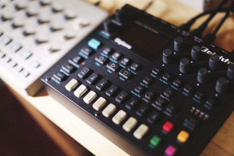 A detailed view of an Elektron synthesizer showcasing buttons and knobs for music production.